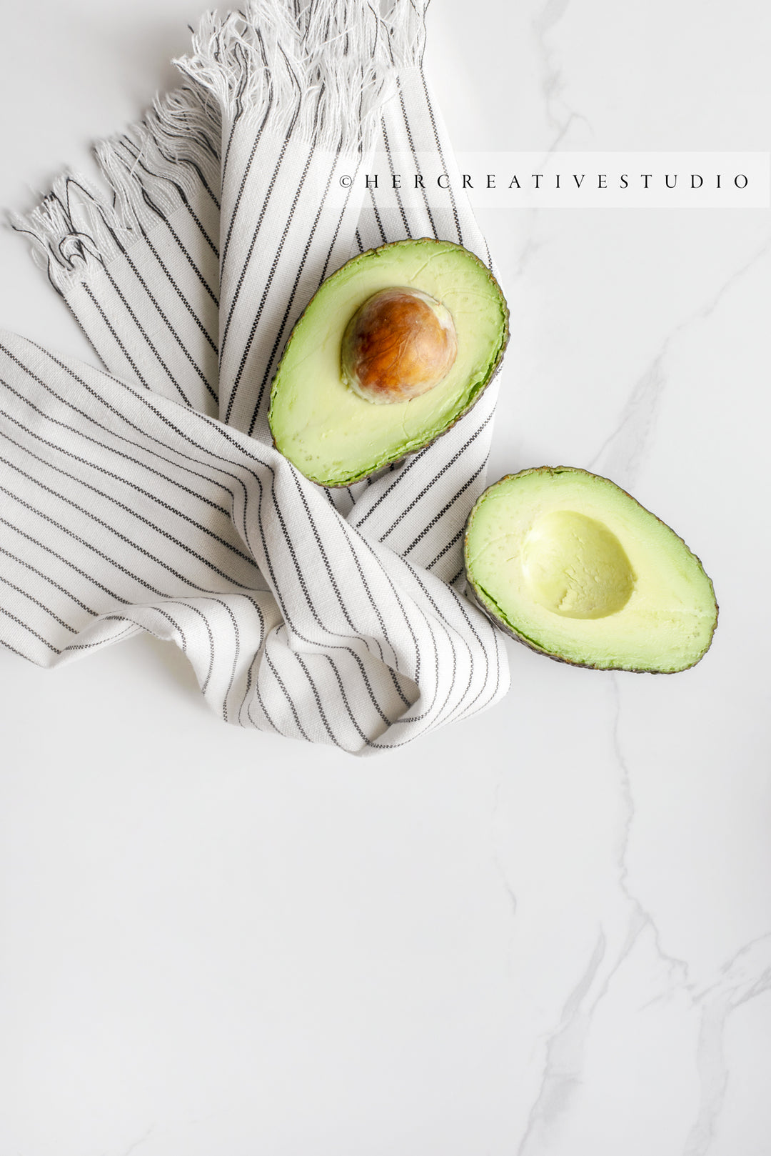 Avocado with Striped Towel on Marble background