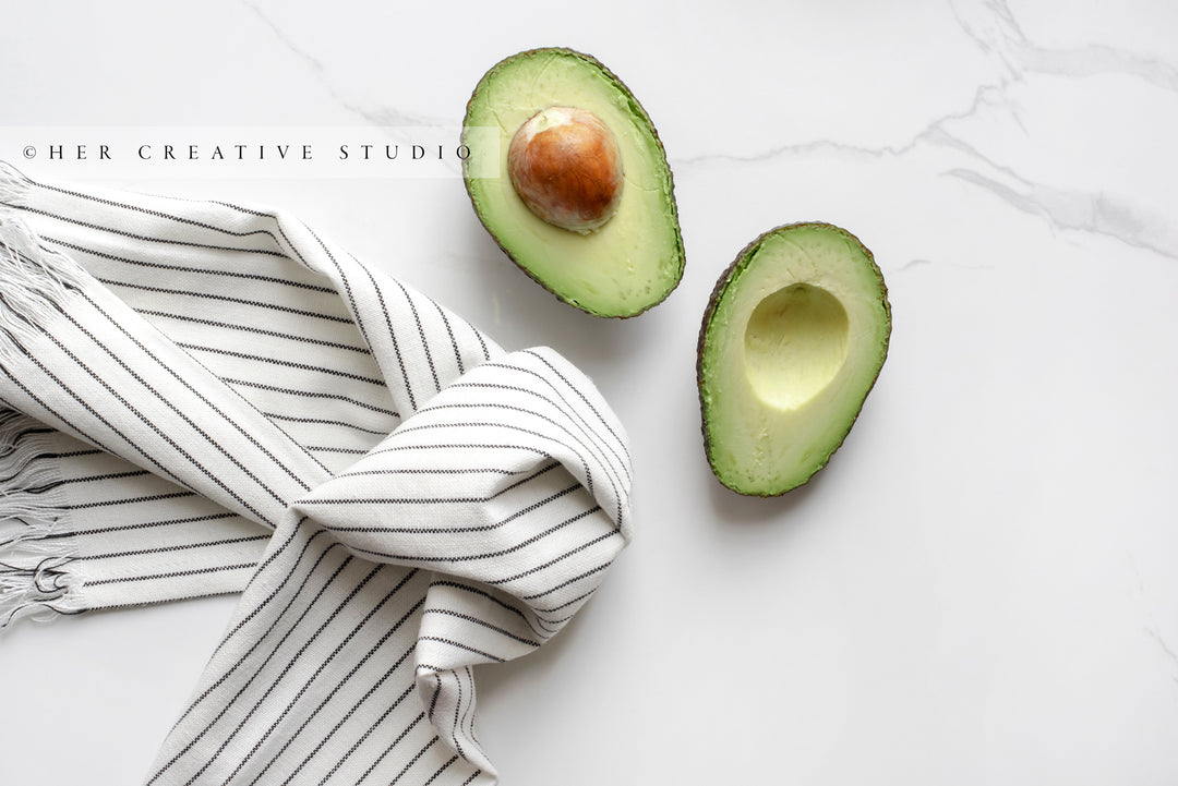 Avocado, Striped Dish Cloth on Marble Background