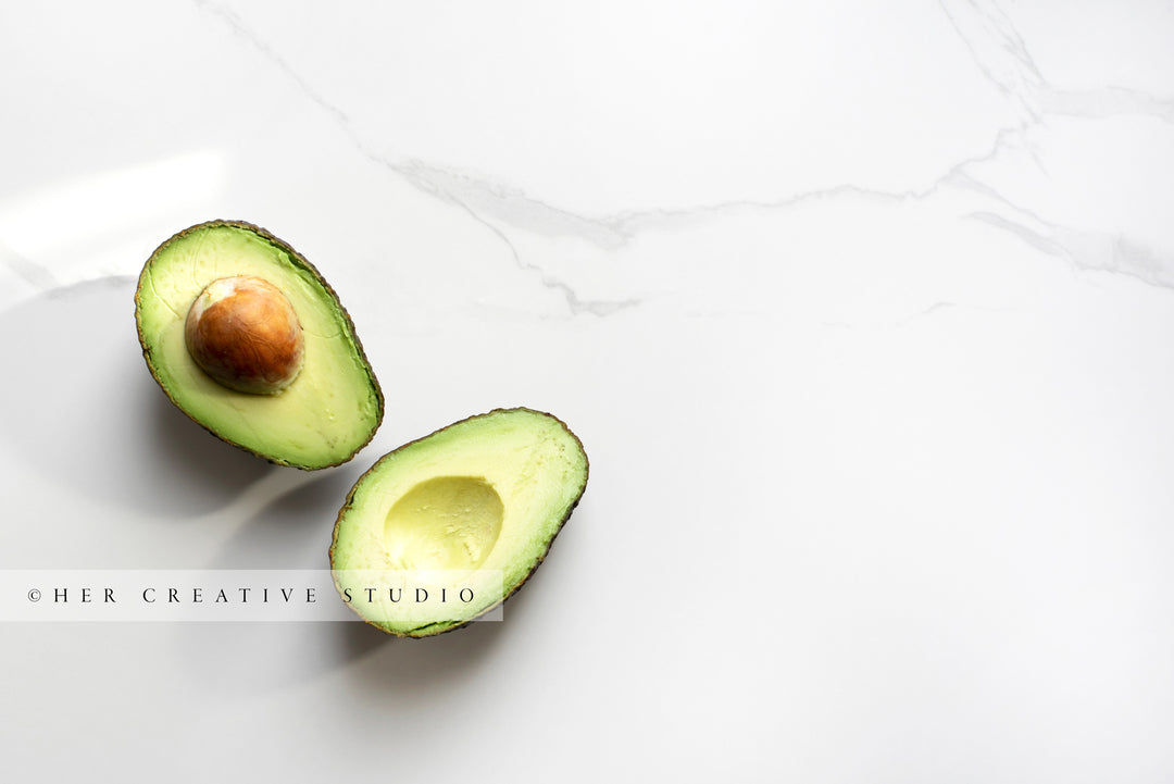 Avocado in Half on Marble Background