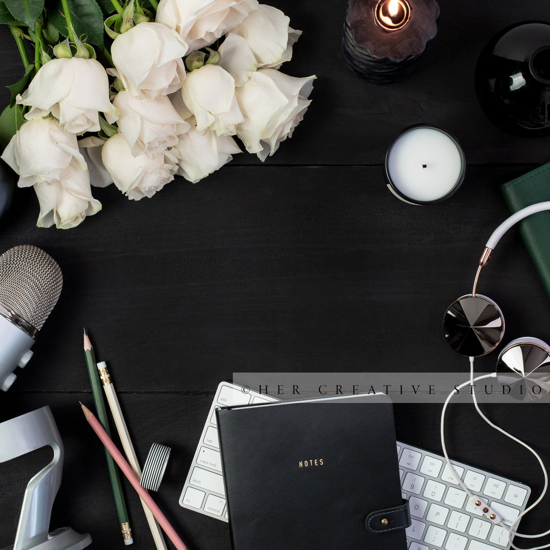 Roses, Notebook & Headphones on Black Desk