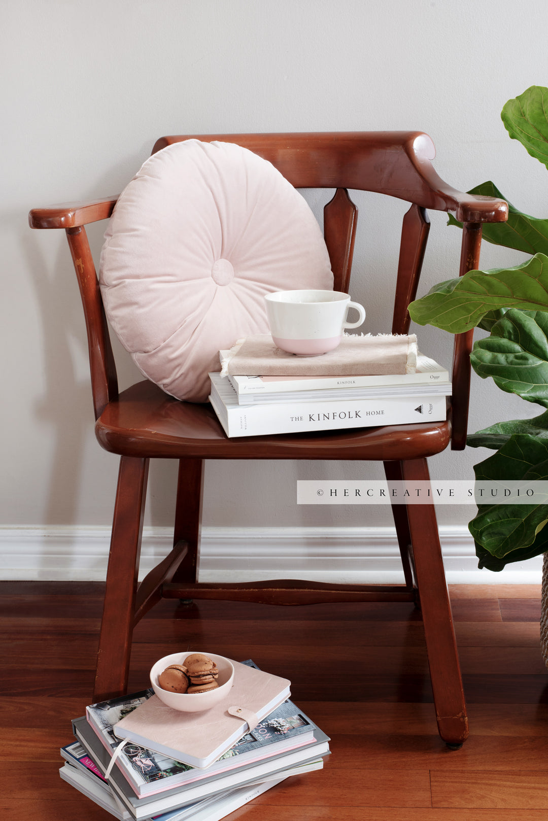 Coffee and Books on Brown Chair. Digital Image.