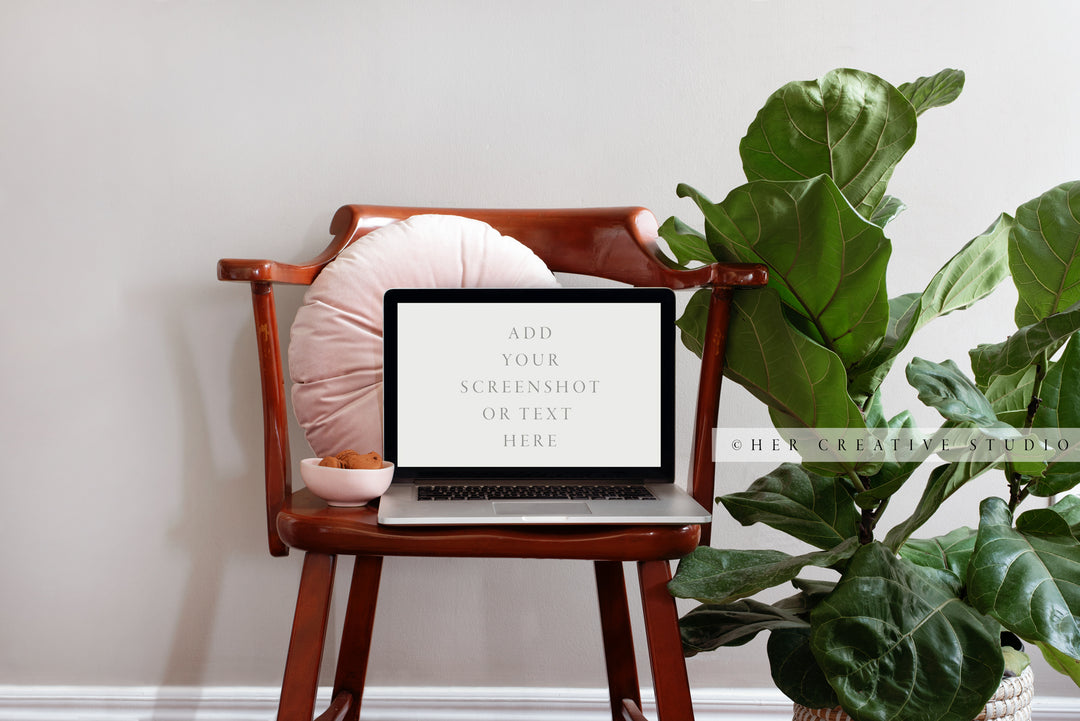 Laptop with Monstera Plant & Brown Chair. Digital Image.