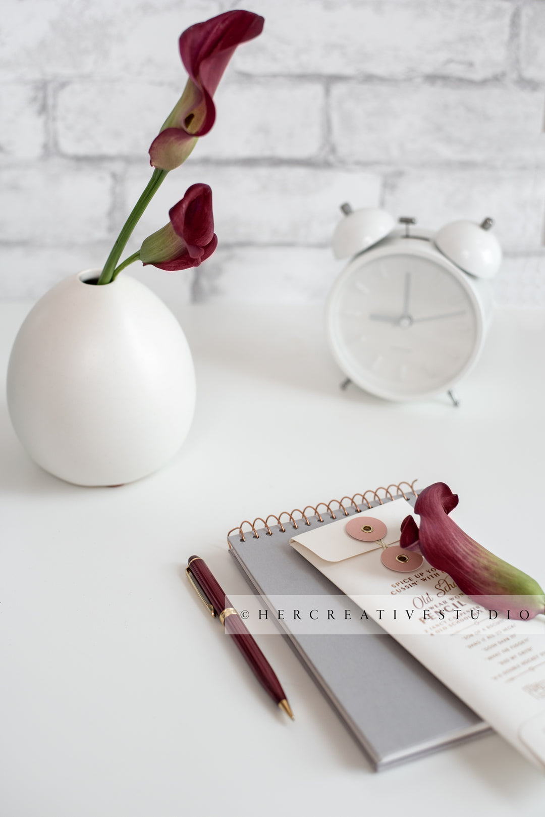 Calla Lilly, Clock & Notebook on White Desk