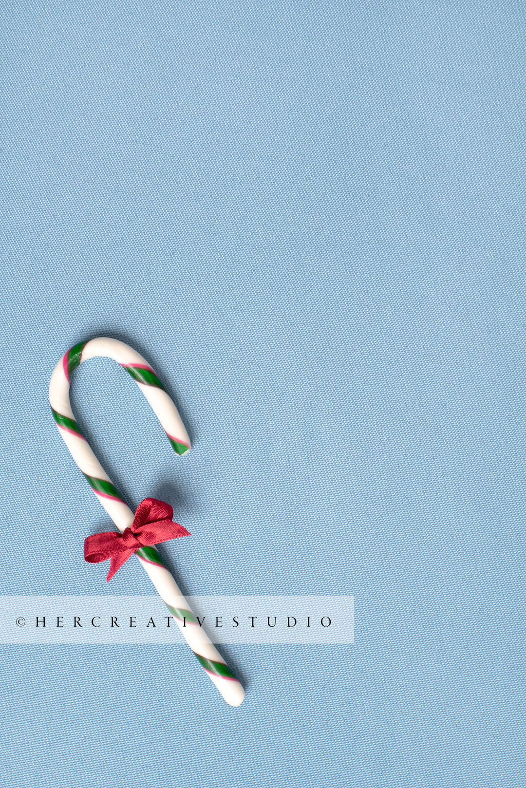 Candy Cane with Red Bow on Sky Blue Background 2