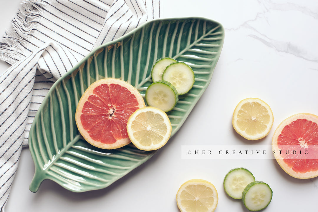 Citrus Slices on leaf Plate. Stock Photo.
