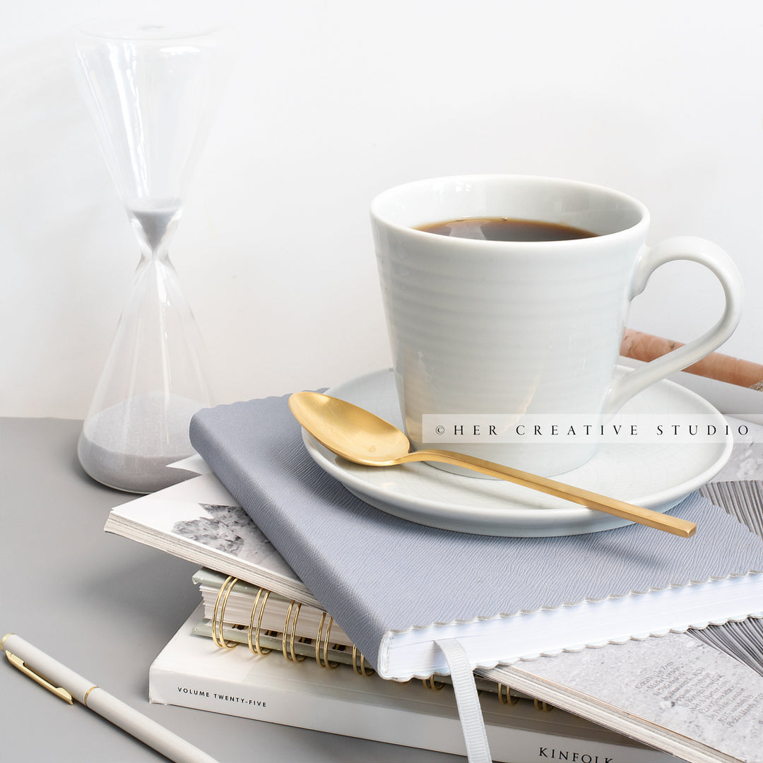 Coffee and Hourglass on Grey Workspace. Stock Image
