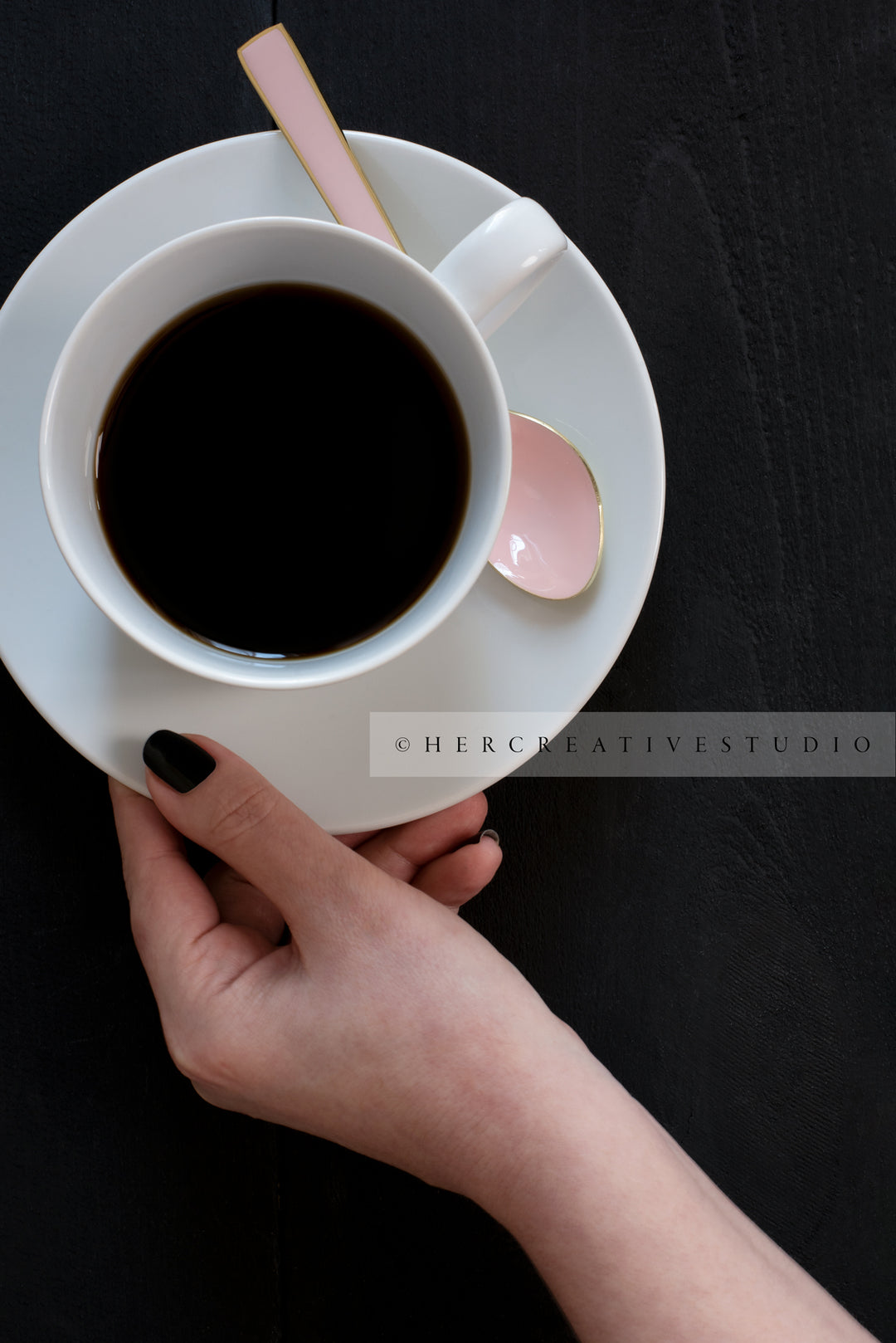 Hand Holding Coffee on Black Background