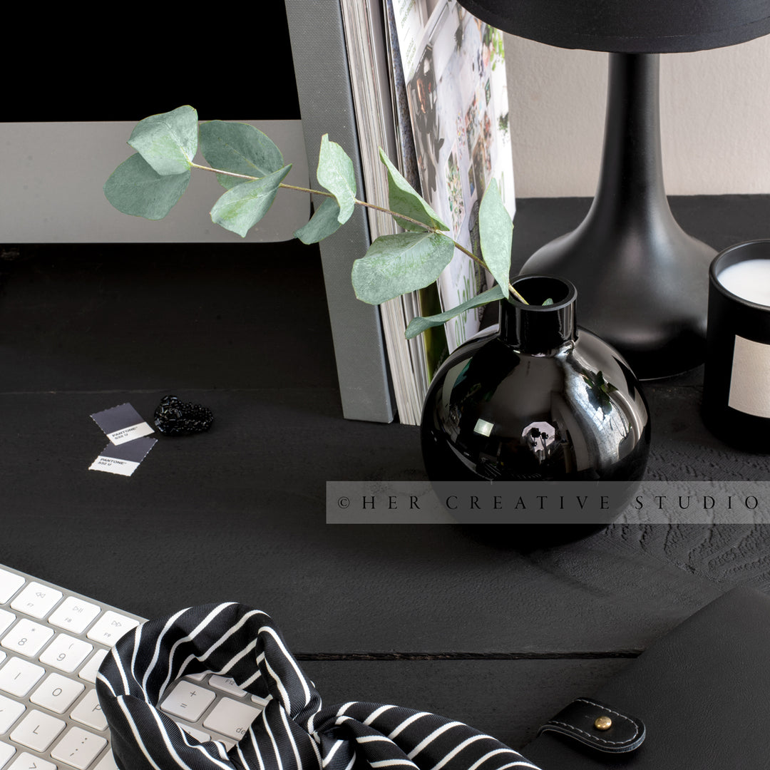 Eucalyptus in vase on Black Desk