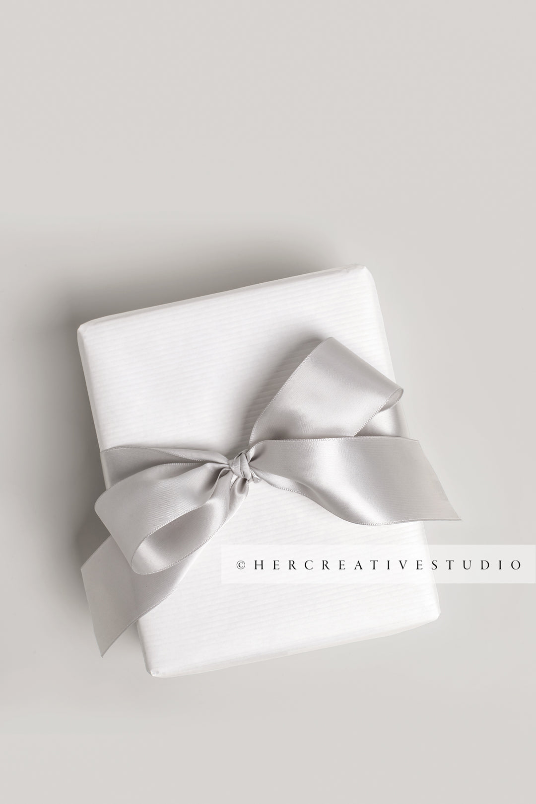 Holiday Gift with Grey Ribbon on Grey Background, Styled Image