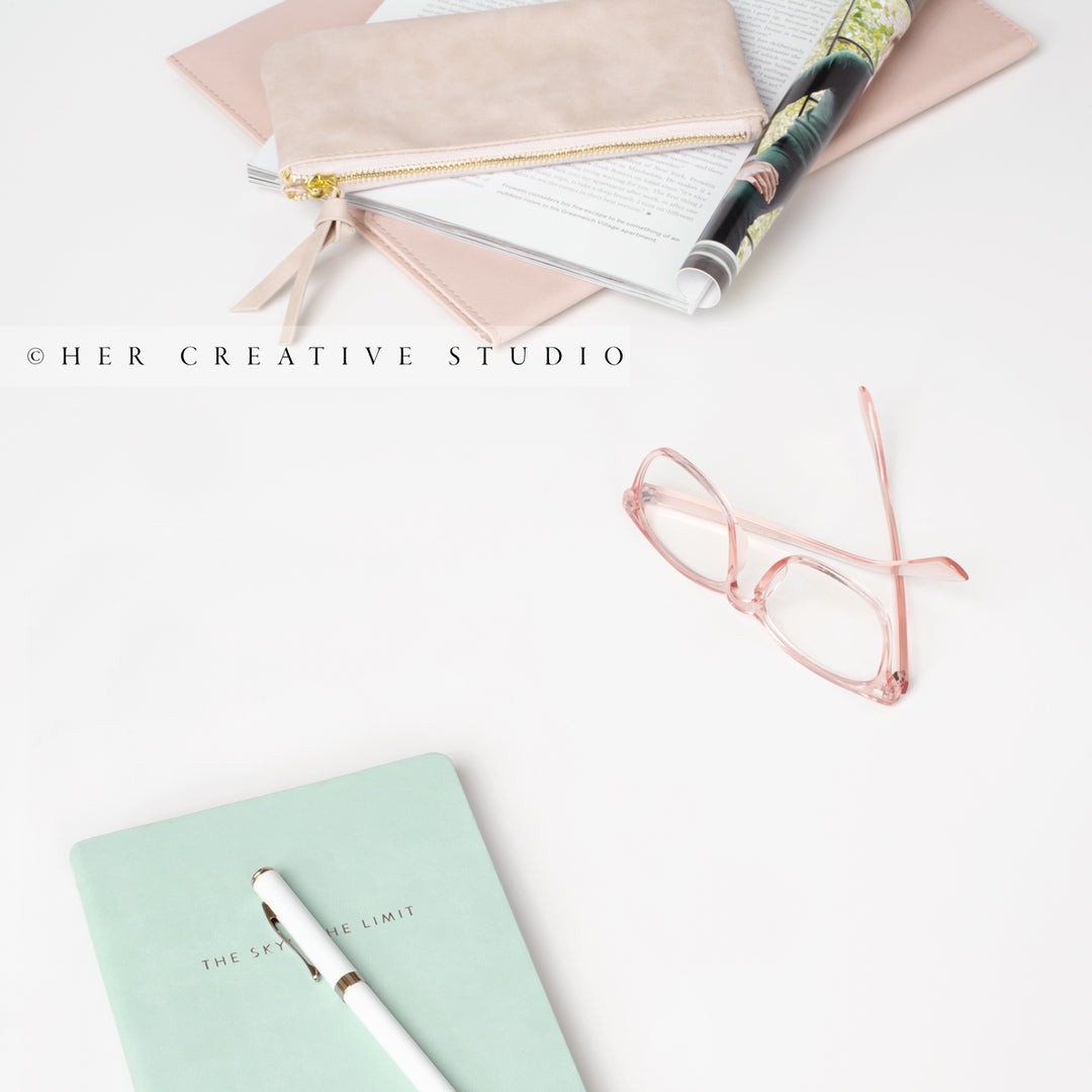 Notebook & Glasses on White Background