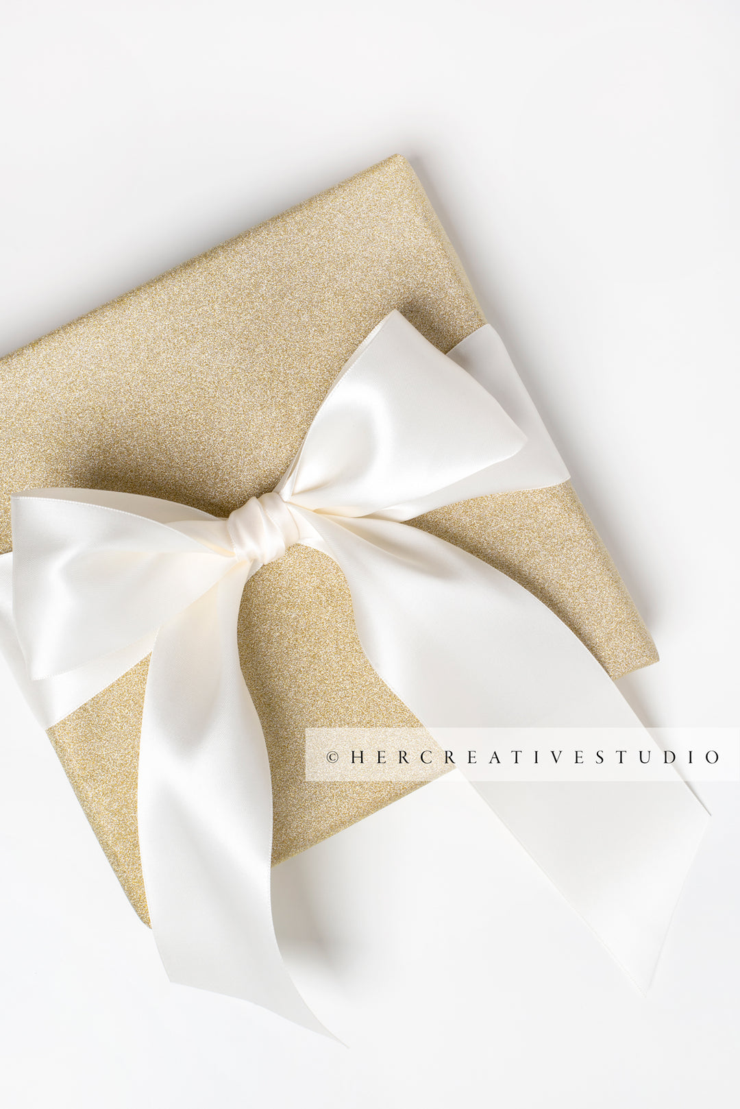 Gold Present with White Ribbon on White Background