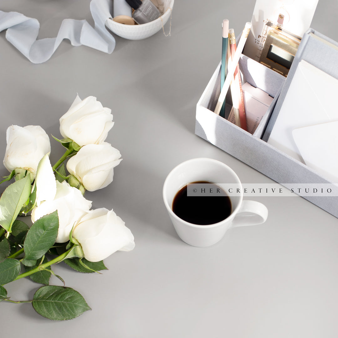 Coffee and Roses on Grey Workspace. Stock Image