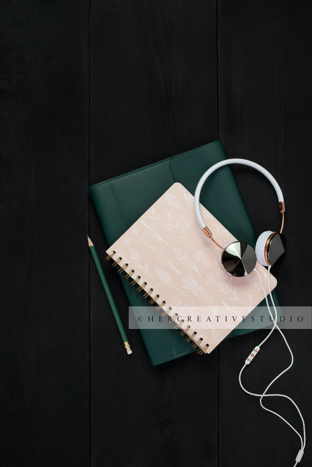 Notebooks, Headphones & Pencil on Black Desk