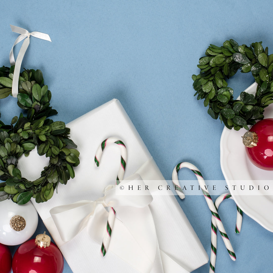 Holiday Home, Gift & Mini Wreath Flatlay on Sky Blue Background