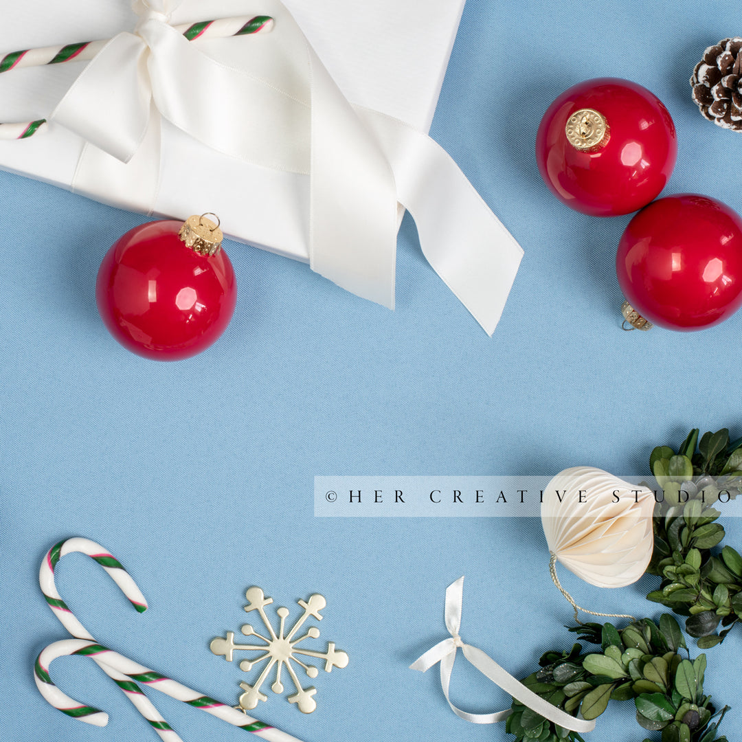 Holiday Ornaments & Candy Cane on Sky Blue Background