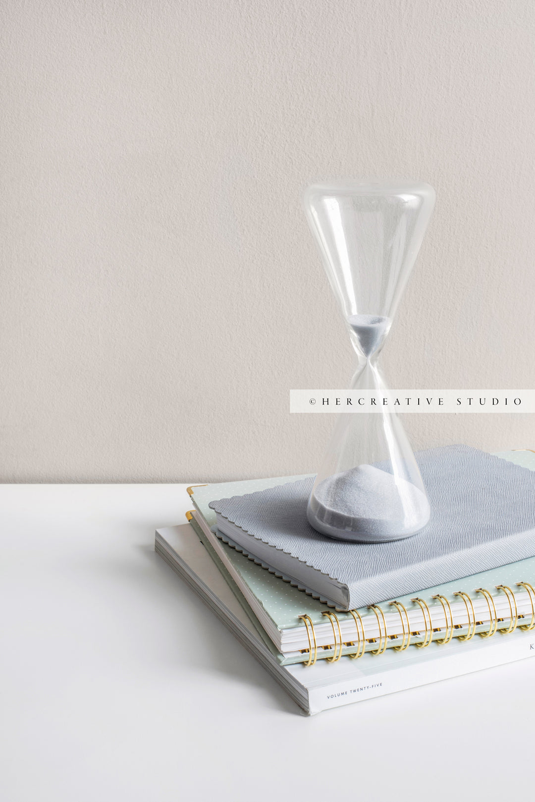 Hourglass on a Stack of Notebooks. Stock Image