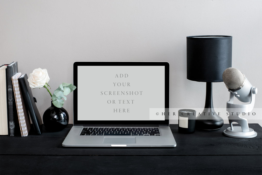 Laptop with Microphone on Black Desk