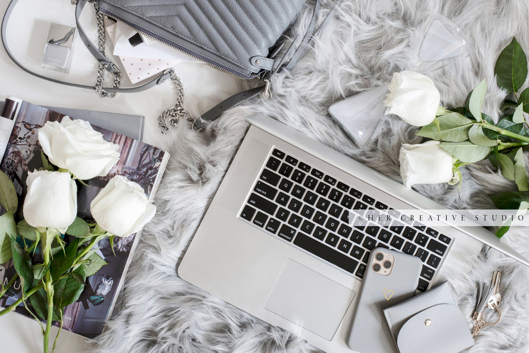 Laptop & Roses on Grey Workspace. Stock Image