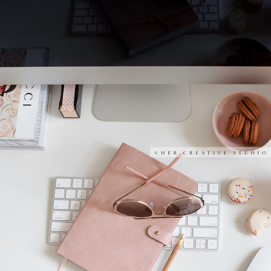 Macarons, Sunglasses & Notebook on Desk. Digital Image.