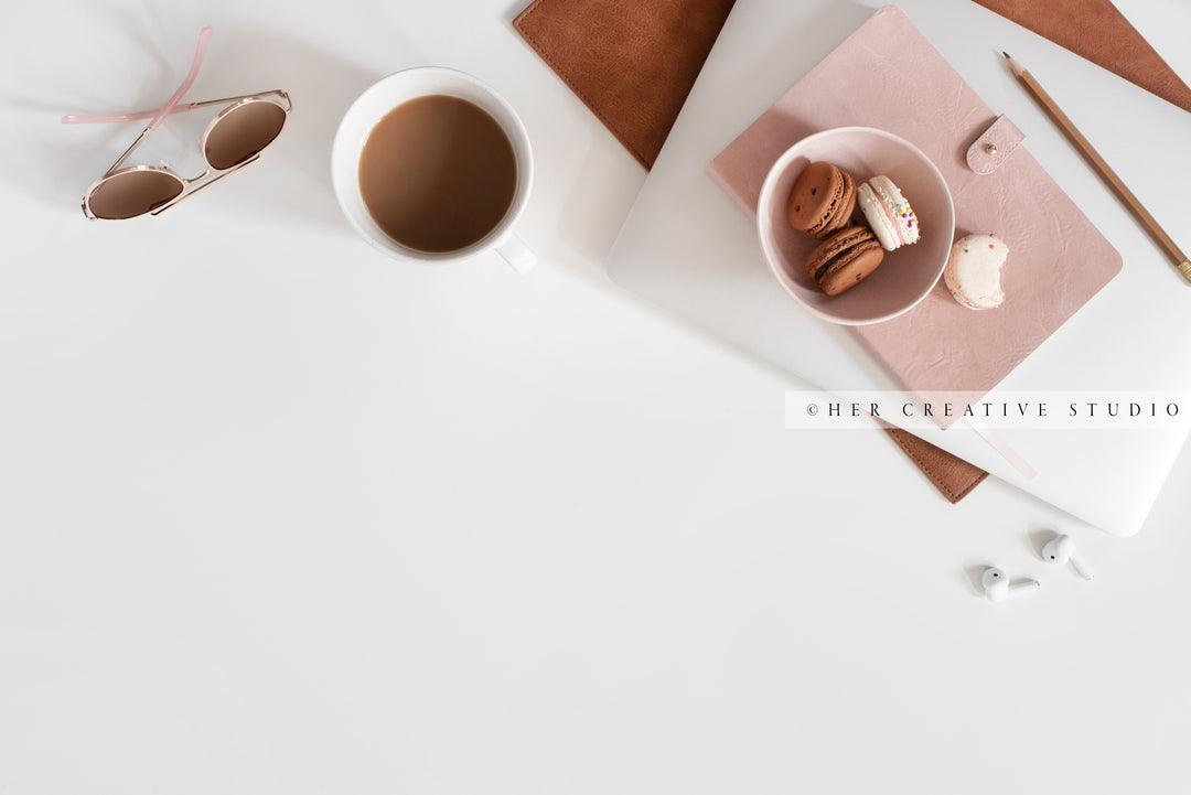 Coffee & Macarons on White Workspace. Digital Image.