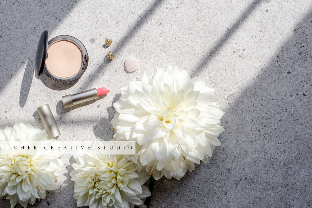 Makeup & Dahlia on Table in Sunlight, Styled Stock