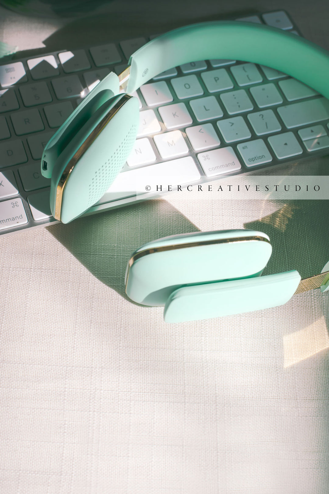 Mint Green Headphone on Keyboard in Sunshine