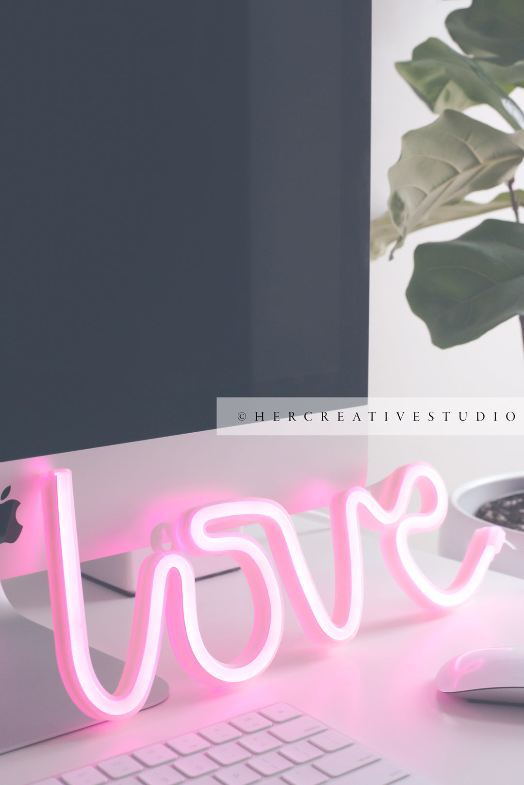 Neon Pink 'Love' on Workspace, Styled Stock Image