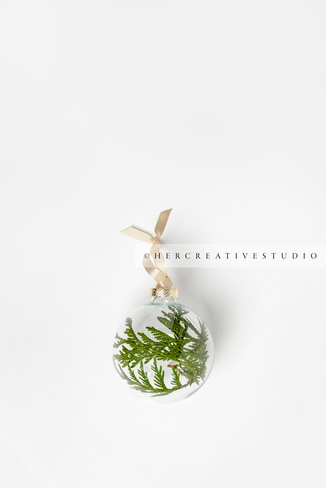 Clear & Green Tree Ornament on White Background, Styled Image