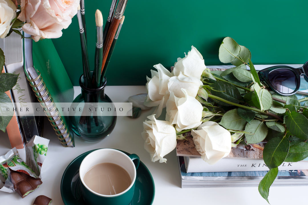 Coffee, Paintbrushes & Roses on Desk. Digital Stock Image