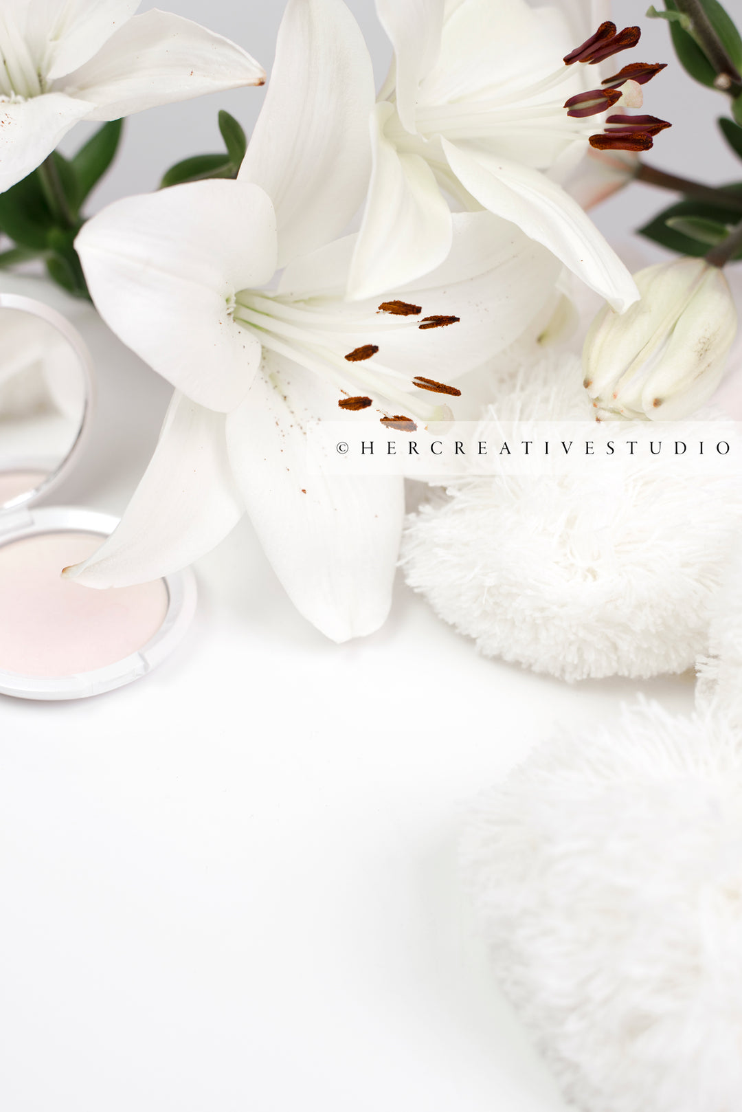 Lillies & Makeup on White Tabletop, Styled Stock